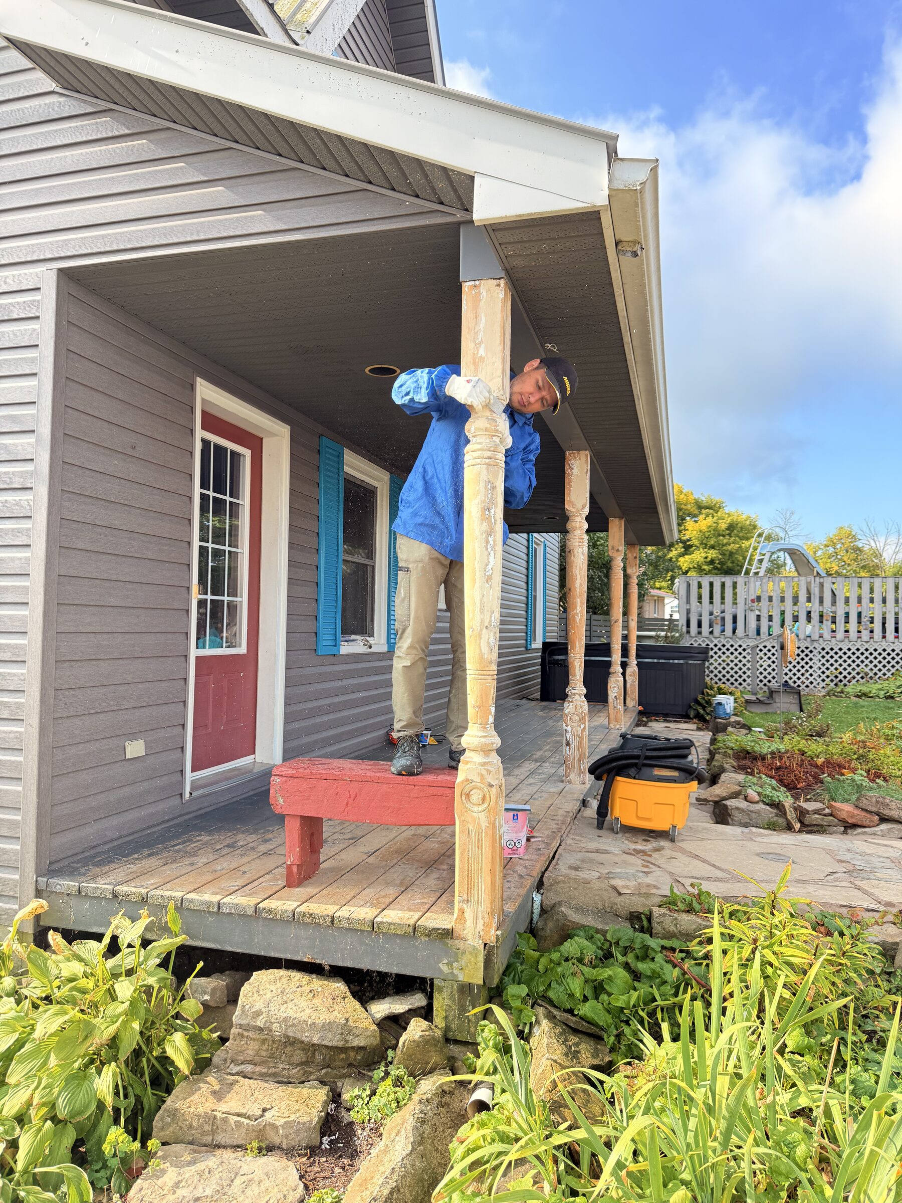 Before: Bare wood turned porch posts being prepped on a Spencerville home